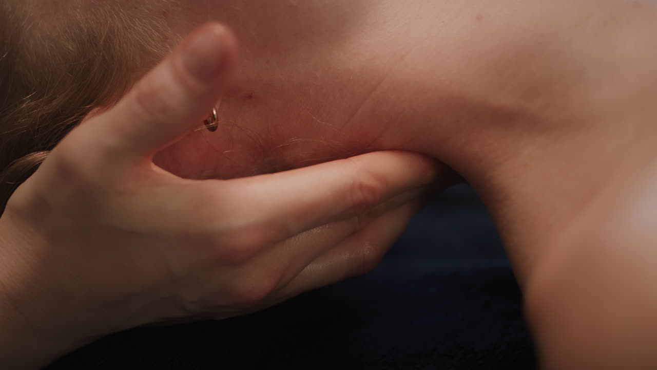 Massage therapist applying targeted pressure to the upper back